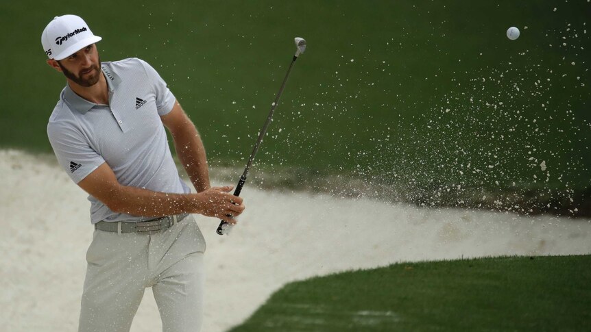 Dustin Johnson hits from a bunker during a practice round ahead of the Masters on April 5, 2017.
