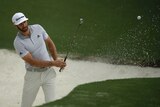 Dustin Johnson hits from a bunker during a practice round ahead of the Masters on April 5, 2017.