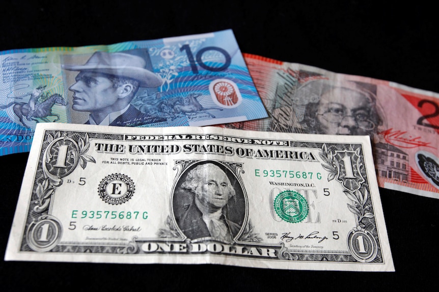A US dollar note is pictured alongside an Australian 10 dollar and 20 dollar bill.