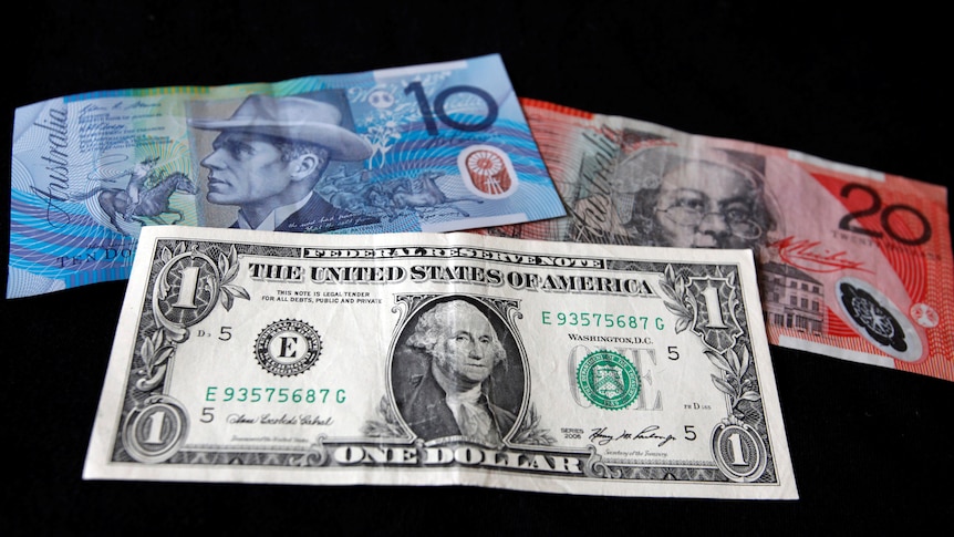 A US dollar note is pictured alongside an Australian 10 dollar and 20 dollar bill.