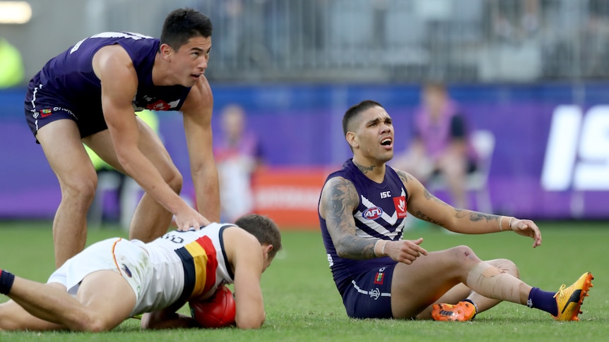 Fremantle's Michael Walters reacts after tackle