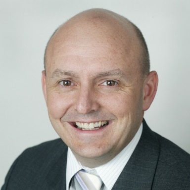 Picture of Dr Richard Denniss smiling.