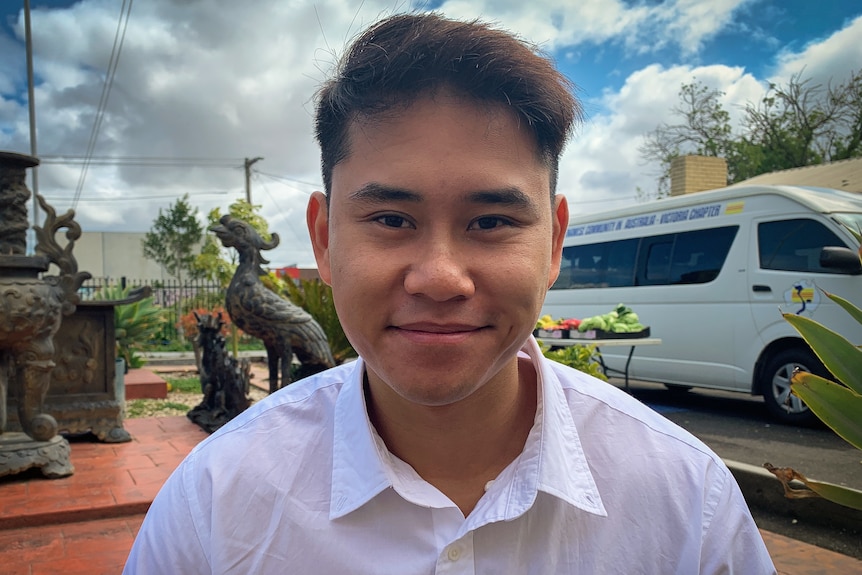 A man wearing a white collared shirt.