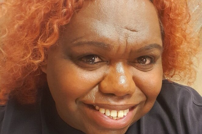 Close up of a woman with red hair.