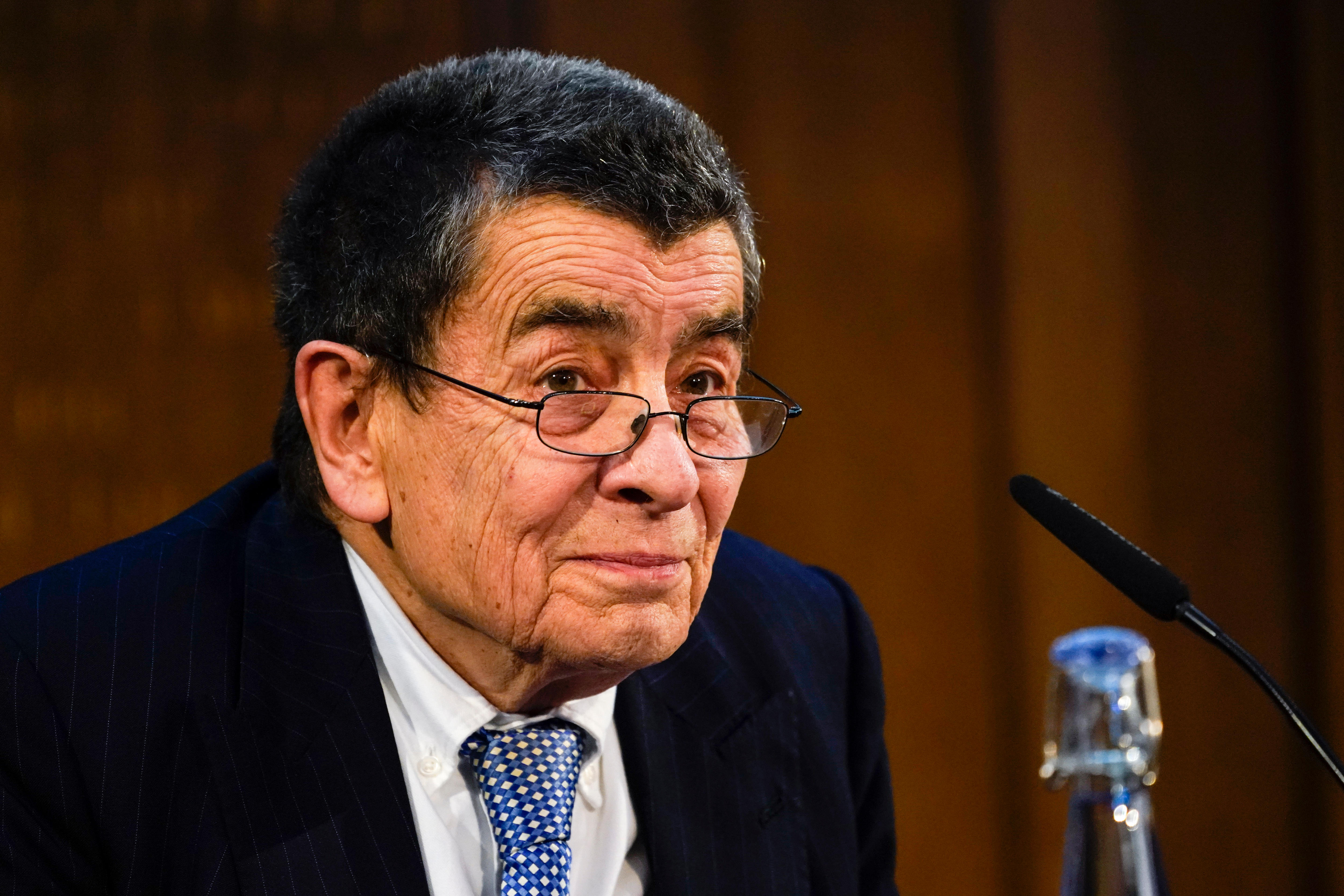 Close up of tribunal chair Geoffrey Nice seated at panel.