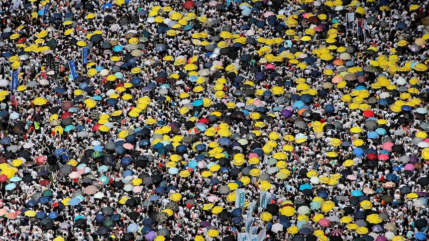Demonstrators hold yellow umbrellas, the symbol of the Occupy Central movement, during a protest.
