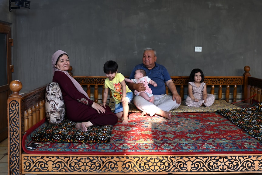 Matluba Samarova and Muhiddin Omonov with their granddaughters sit all together