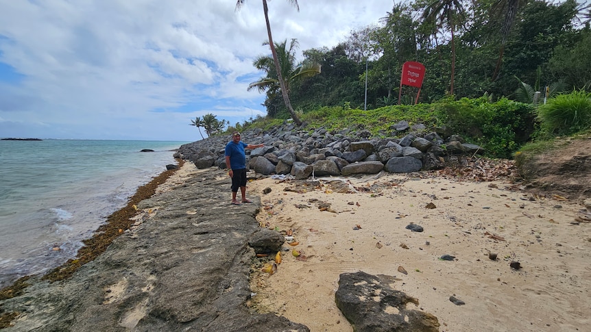 Tagaqe Village Turaga ni Koro, Apisalome Baroka Junior points at a pile of rocks used to protect a part of the village coast front.