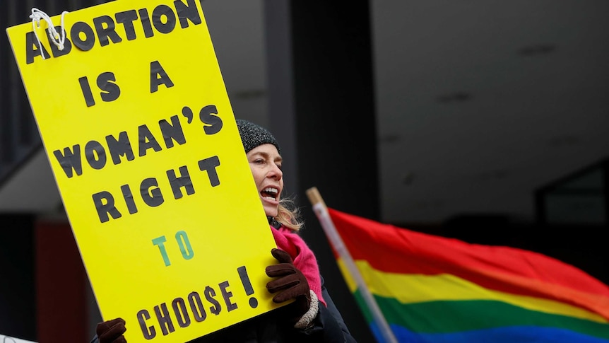 An anti-Donald Trump demonstrator holds a sign at a protest reading: "Abortion is a woman's right to choose!"