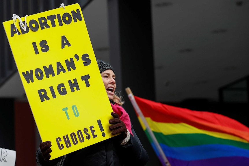 An anti-Donald Trump demonstrator holds a sign at a protest reading: "Abortion is a woman's right to choose!"