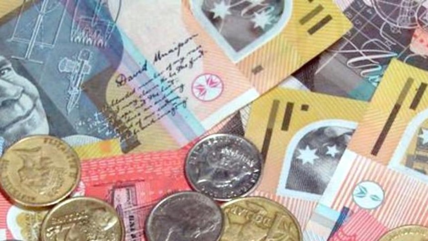 Australian banknotes and coins are spread out on a table.