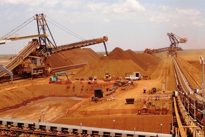 A landscaoe picture of red earth and mining machinery