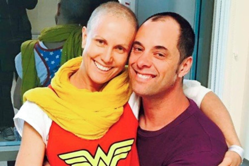 Tania Murphy dons her Wonder Woman costume and sits on Chris's lap for a photo.