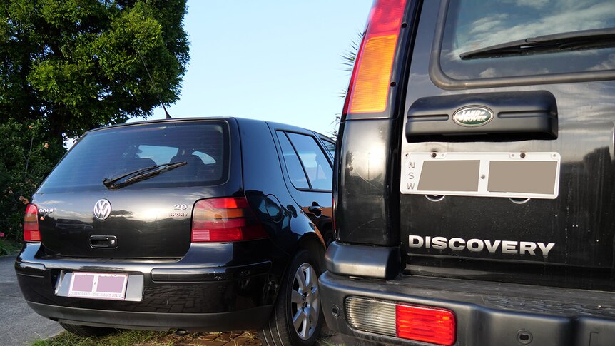 Two cars sitting side by side, one car registered in Queensland and one in New South Wales, both reside at the same address