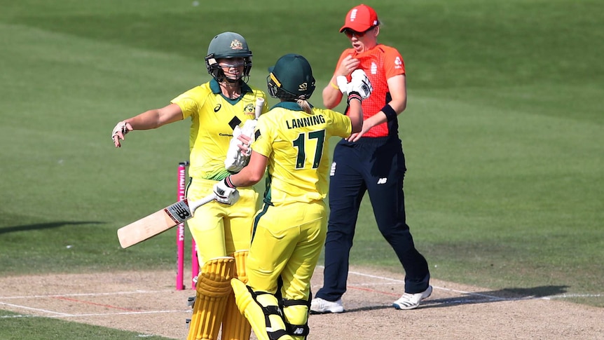 Two cricketers hug as they celebrate a T20 international victory.