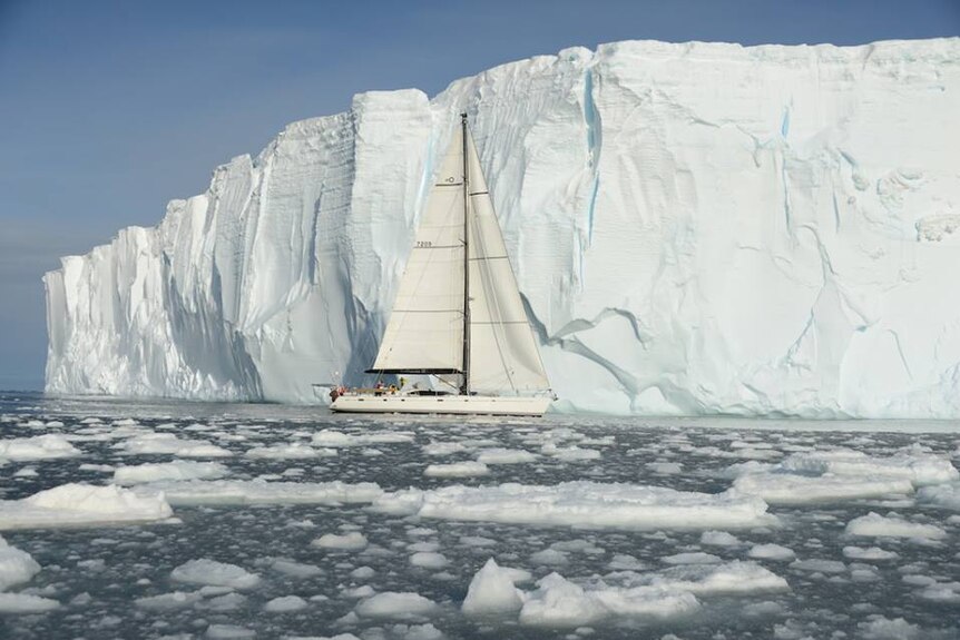 Katharsis II pictured next to Antarctic iceberg.