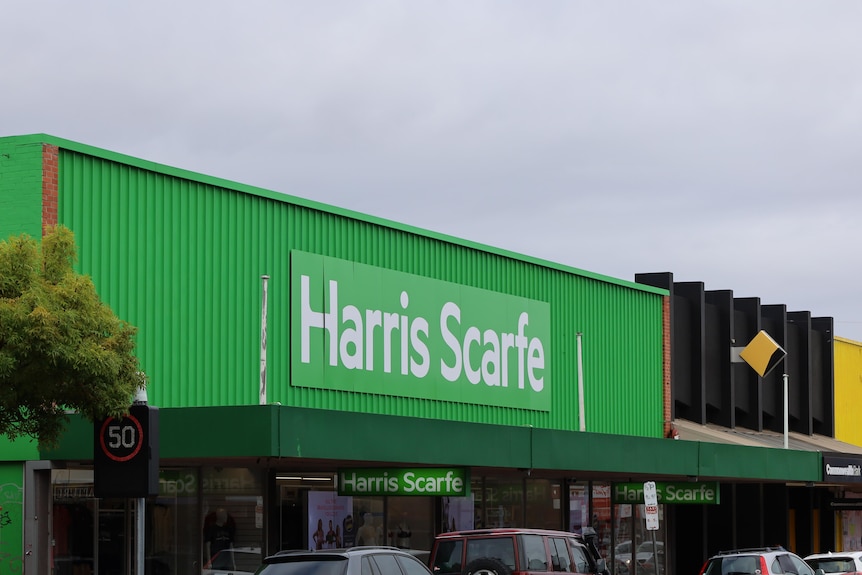 A green sign on a shop reads: Harris Scarfe