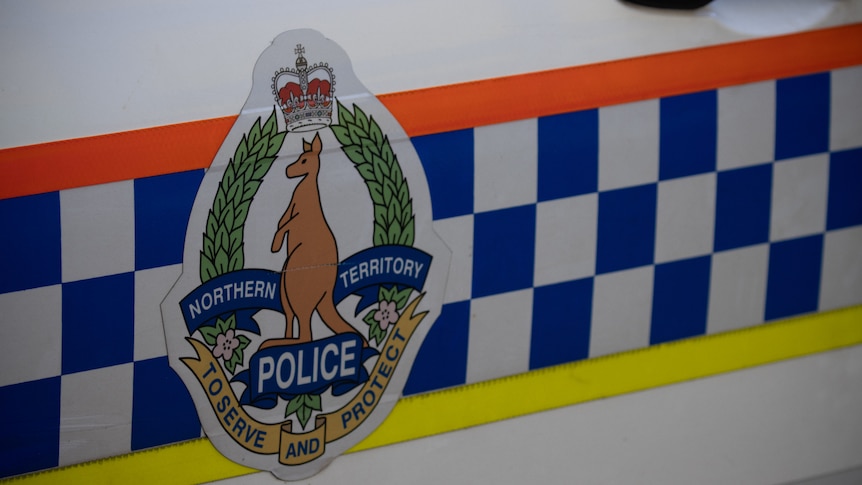 The door of a NT Police car, showing the NT Police logo. 