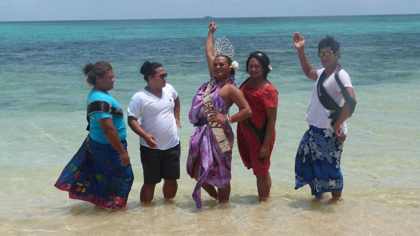 Tongan 'leitis' pose on the beach
