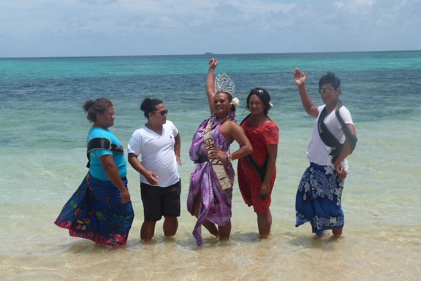 Tongan 'leitis' pose on the beach