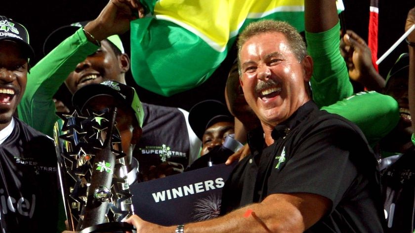 Sir Allen Stanford, right, presents the trophy to Superstars captain Chris Gayle