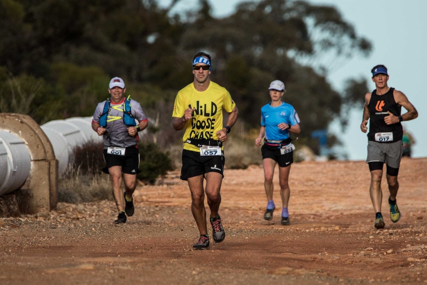 Runners in marathon on dirt track