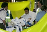 An asylum seeker on a stretcher is wheeled from an ambulance at Royal Perth Hospital