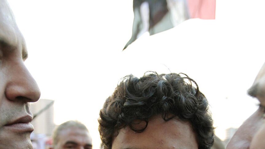 Google Inc executive Wael Ghonim is escorted through Tahrir Square