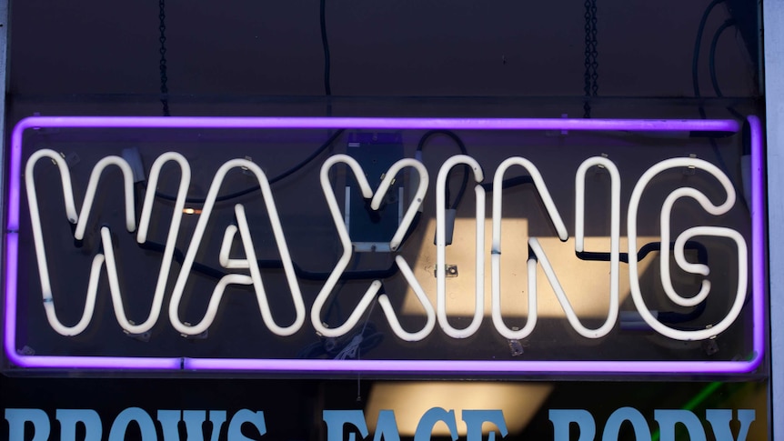 A light-up waxing sign.