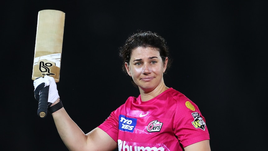 Nicole Bolton fights back tears and raises her bat as she heads off the WBBL field for the final time