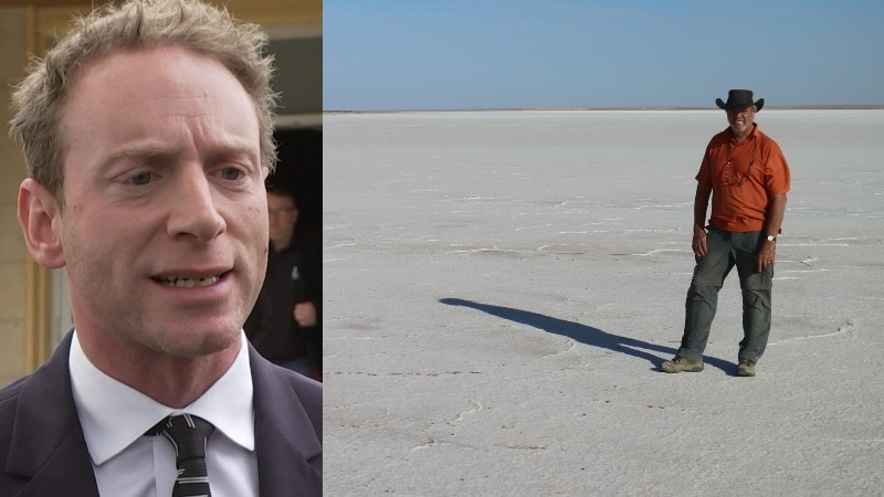 man in suit and tie with fair hair talking and photo of man in a hat at distance standing on a salt lake