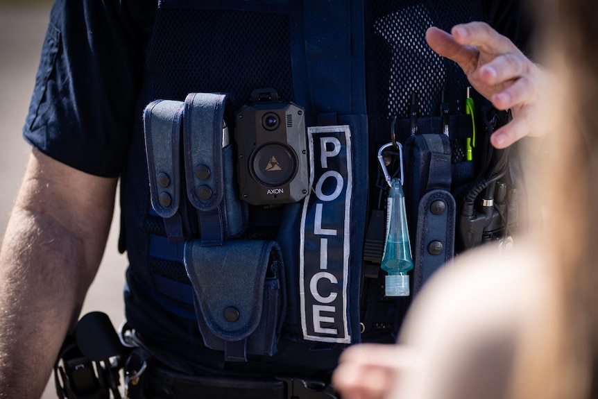 A police officer's torso showing a body cam