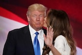 Donald Trump stands with wife Melania Trump on stage