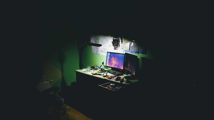 A monitor in a dark room.