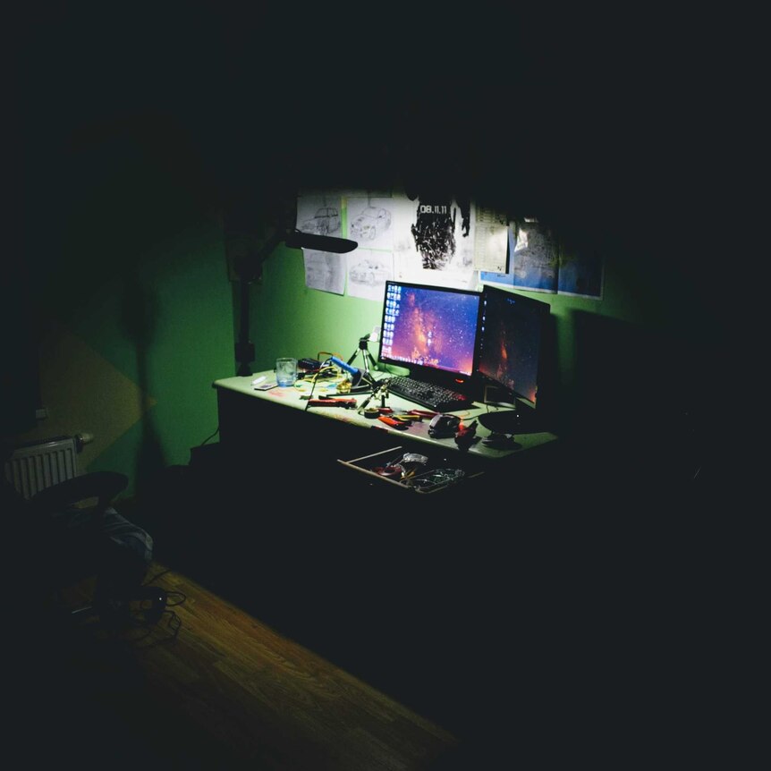 A monitor in a dark room.