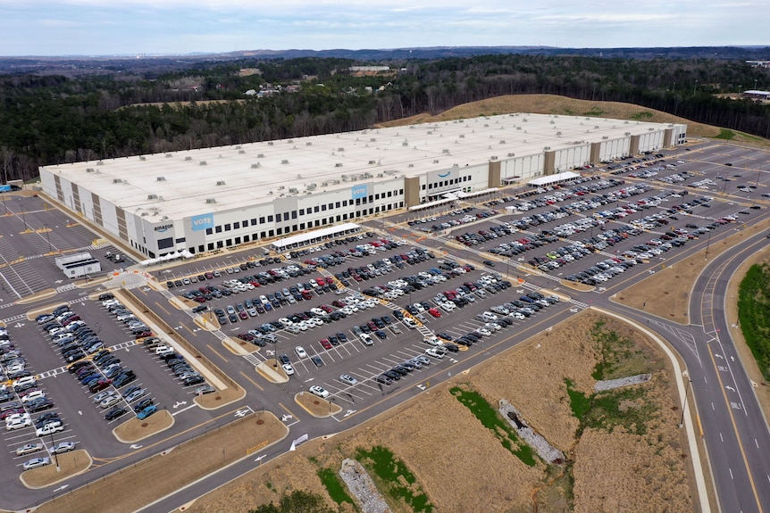 A birds eye view of a massive building and carpark 