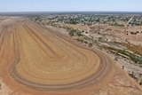 Giant excavated dirt for waterski park in an aerial photo, with Barcaldine town seen in the distance.
