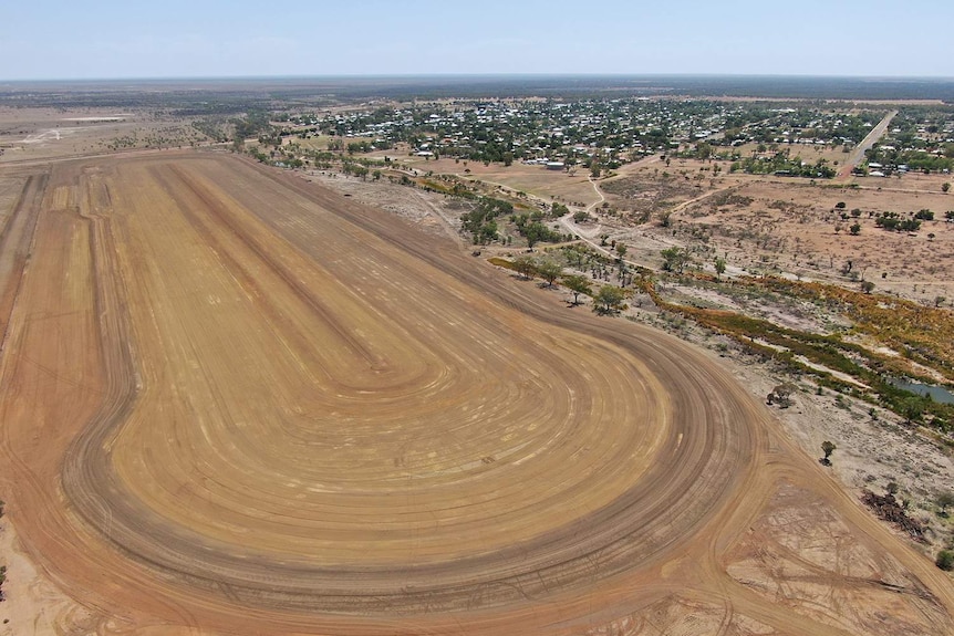 Giant excavated dirt for waterski park in an aerial photo, with Barcaldine town seen in the distance.