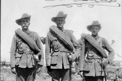 A black and white photo of three officers of the 3rd Battalion in full kit including their bed rolls slung across their chests