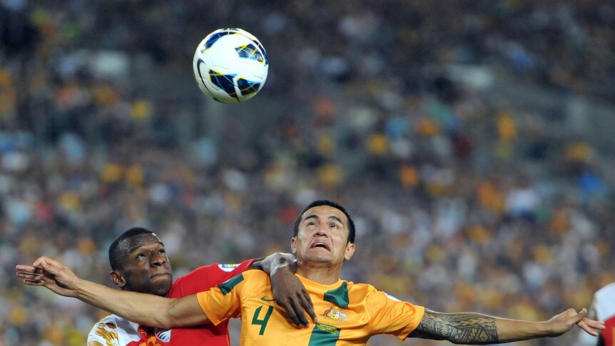 Australia's Tim Cahill (right) competes for the ball with Oman's Abdul-Salam al-Mukhaini during their 2-2 draw in Sydney.