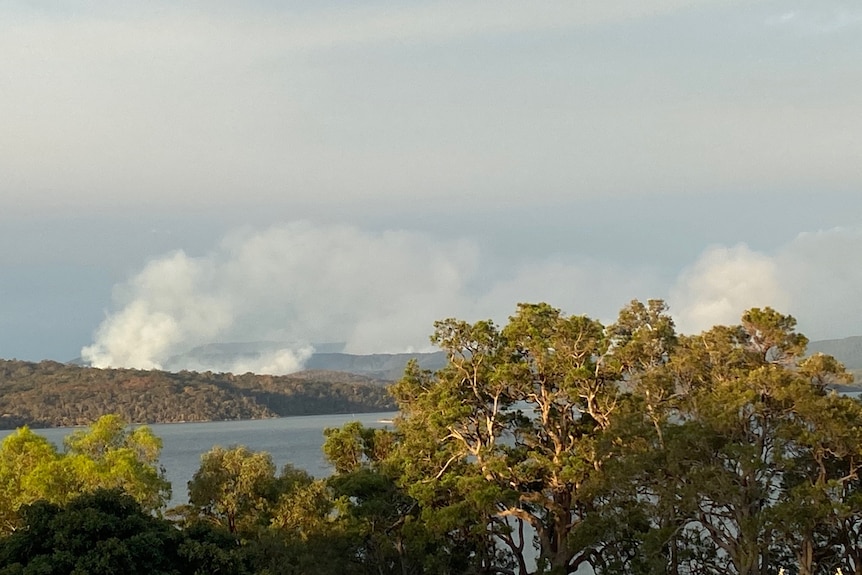 Smoke rising from a hill in Mallacoota during burshfires.