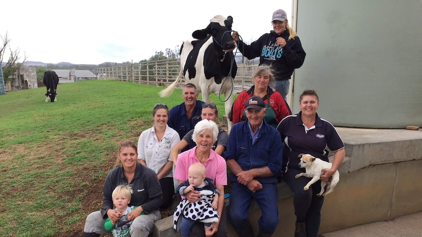 A large extended family smiling at the camera.