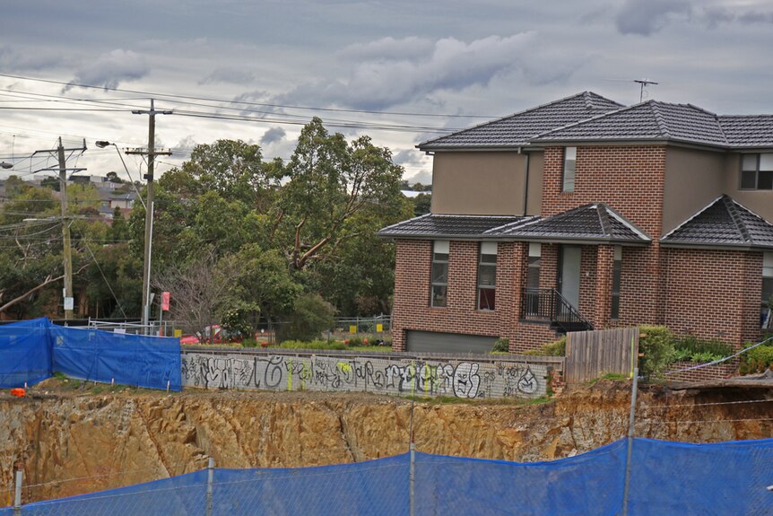 Townhouses perched precariously on the edge of an excavation site in Mount Waverley