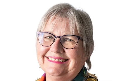 A woman with short grey hair wearing a mayoral chain