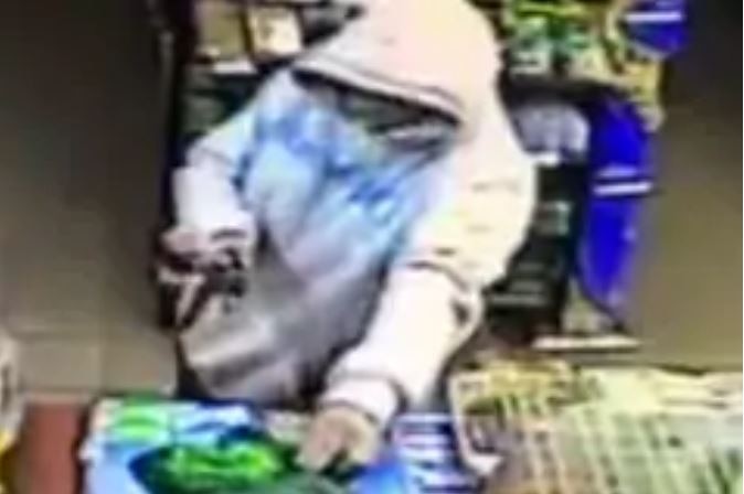 CCTV still of armed robbery in progress, Tasmania.