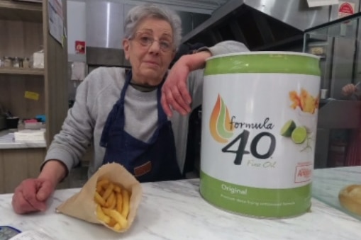 a woman with a vat of cooking oil