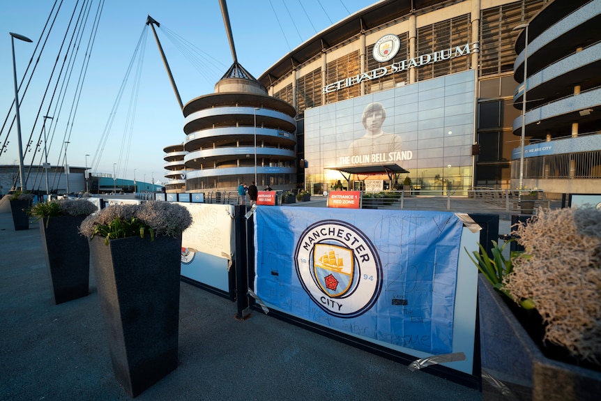 A view from outside a Premier League team's stadium, with a banner featuring the team logo.