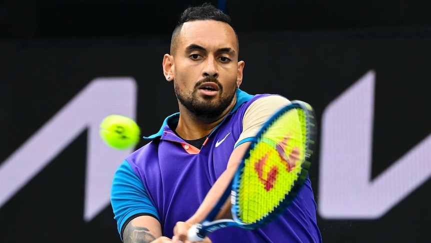 Nick Kyrgios plays a double-handed backhand against Dominic Thiem at the Australian Open.