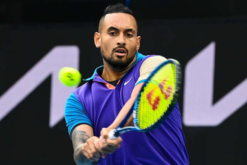 Nick Kyrgios plays a double-handed backhand against Dominic Thiem at the Australian Open.
