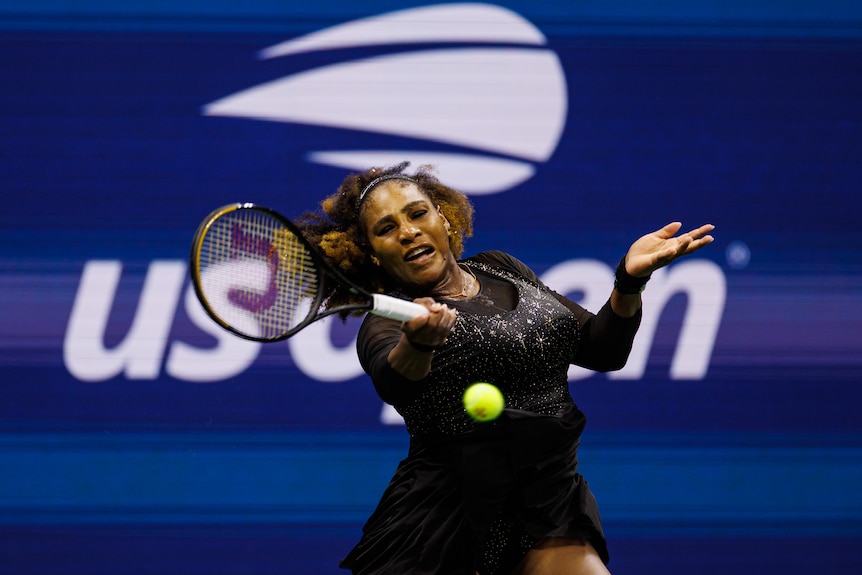 Tennis star Serena Williams reaches out to her right with her racquet to return the ball during a US Open match. 